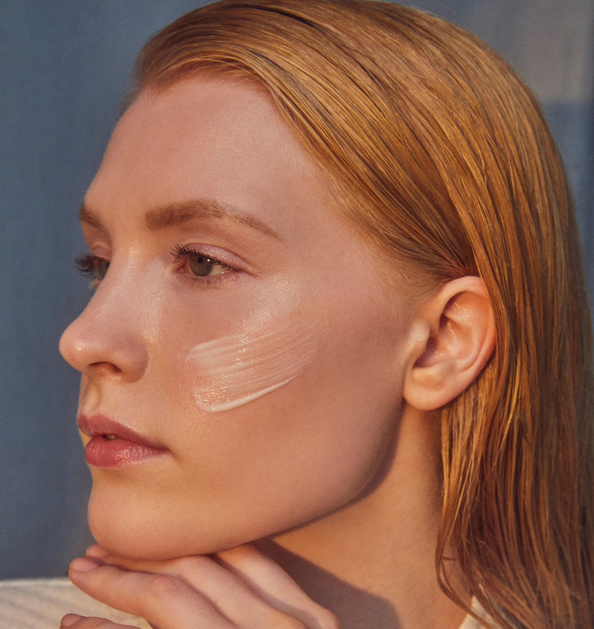woman with swatch of Force De Vie Creme Luxe on her cheek